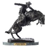 After Frederic Remington Bronco Buster:, a patinated bronze study of a bronco rider,