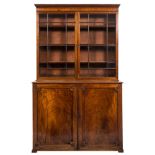 An early 19th Century mahogany bookcase:, the upper part with a moulded cornice,