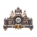A Paris porcelain figural mantel clock: the cartouche shaped case with central mask flanked by