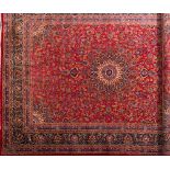 A Kashan carpet:, the red field with a central arabesque flowerhead pole medallion,