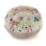 A George Bacchus close pack glass paperweight: set with various multi coloured canes and four