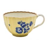 A First Period Worcester tea cup: of reeded form with ear-shaped handle,