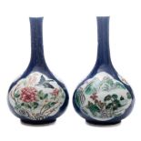 A pair of Chinese famille rose bottle vases: painted with panels of peacocks,