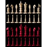 A 19th century Indian carved ivory 'Burmese' pattern chess set: stained red and left natural,