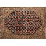 A Feraghan rug:, the indigo field with a Mina Khani geometric lozenge and medallion design,