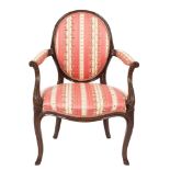 An 18th Century carved mahogany open armchair:, in the French Hepplewhite taste,