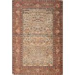 A Teheran rug:, the beige field with all over designs of flowering trees and plants,