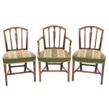 A set of eight George III mahogany dining chairs in the Hepplewhite taste:,