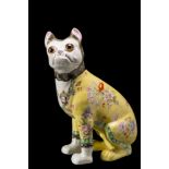 A Galle-style pottery pug: modelled seated and transfer decorated with flowers on a yellow ground,