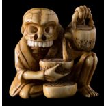 A 20th century Japanese carved ivory netsuke: of a skeleton pouring tea from a teapot into a bowl,