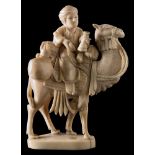 A late 19th century Indian carved sectional ivory figure: of a merchant riding on the back of a