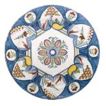 A mid 18th century Dutch polychrome delftware charger: painted with stylised flowers,