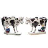 A close pair of North Country pottery cow and milkmaid creamers: modelled standing four square with