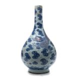 A Chinese underglaze blue and copper-red bottle vase: boldly painted with two large dragons amongst