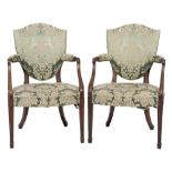 A set of four early 19th Century mahogany open armchairs:, in the Hepplewhite taste,