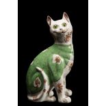 A Galle-style pottery cat: modelled seated and transfer decorated with flowers on a green waistcoat,