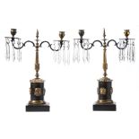 A pair of Regency period ormolu and lustre twin branch lights: the urn-shape nozzles with lobed