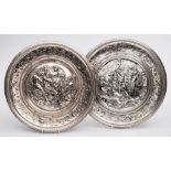 Two Elkington electrotype chargers: the centres embossed with neo-classical scenes,