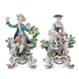 A pair of Bow figures of musicians: in the form of a lady playing a hurdy-gurdy, a dog at her feet,