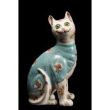 A Galle-style pottery cat: modelled seated and transfer decorated with flowers on a pale blue