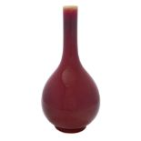 A Chinese 'sang-de-boeuf' bottle vase: covered with a copper-red glaze thinning at the neck,