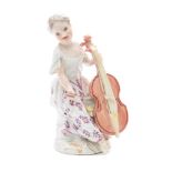 A Meissen porcelain figure of a lady musician: seated playing a cello,