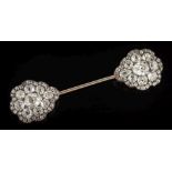 A diamond mounted jabot pin: with two pear-shaped clusters,