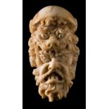 A 19th century Continental carved ivory cane handle: with lion mask and grotesque mask decoration,