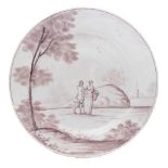 A Bristol delftware plate: painted in manganese with a lady and gentleman standing in an extensive