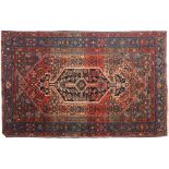 A Hamadan rug:, the shaped rose field with an indigo hooked hexagonal pole medallion,