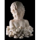 A 19th century carved white marble bust of a child: surrounded by a floral garland.