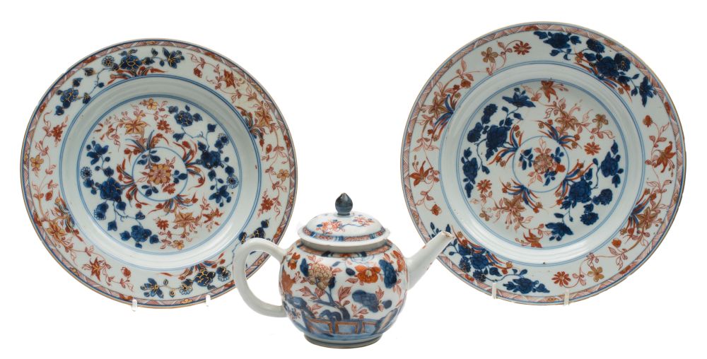 A pair of Chinese 'Imari' plates and a similar small teapot and cover: painted with flowers and