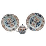 A pair of Chinese 'Imari' plates and a similar small teapot and cover: painted with flowers and