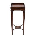 A Georgian mahogany square urn table:, with undulating galleried top and fitted with a candle slide,