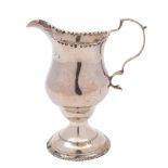 An early George III silver pedestal cream jug: of baluster form and double scroll handle,