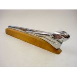 A 1949/50 Dodge chrome plated Ram car mascot:, on later wooden base 41cm long.