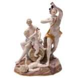 A large Meissen porcelain bacchanalian group: in the form of Bacchus holding aloft a bunch of
