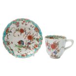 A First Period Worcester cup and saucer: of fluted form, the cup with entwined twig handle,