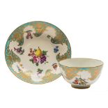 A First Period Worcester tea bowl and saucer: painted with a central spray of fruit and flowers