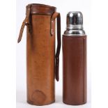 A brown leather mounted Thermos flask in leather hunting case:.