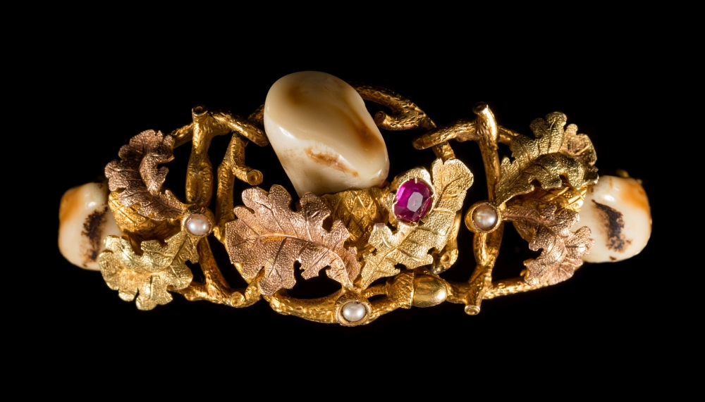 A hunting themed ruby, seed pearl and Stag's tooth mounted bracelet:,