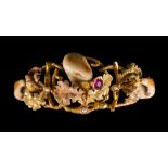 A hunting themed ruby, seed pearl and Stag's tooth mounted bracelet:,
