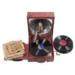 A red leather cased Decca portable wind-up gramophone: and quantity of 78rpm records.