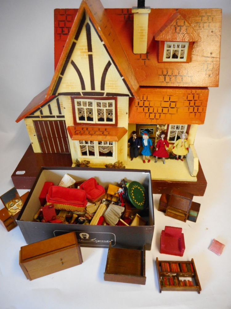 An orange painted wooden dolls house: with single hinged front enclosing one ground floor and one