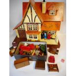 An orange painted wooden dolls house: with single hinged front enclosing one ground floor and one
