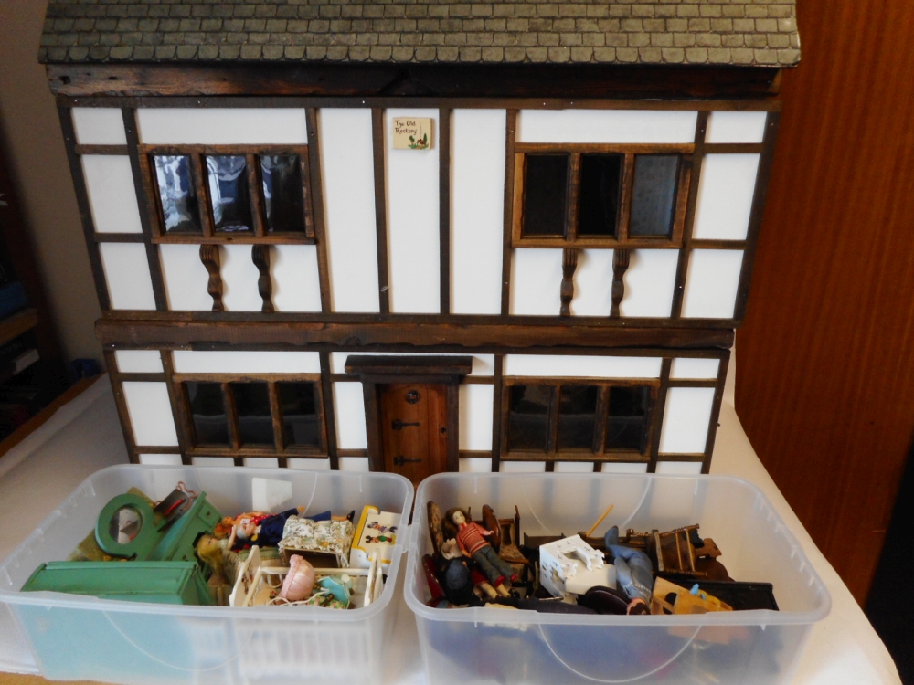 A black and white mock Tudor style dolls house: with double hinged front enclosing two ground floor