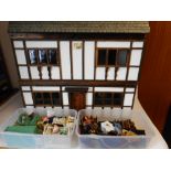 A black and white mock Tudor style dolls house: with double hinged front enclosing two ground floor