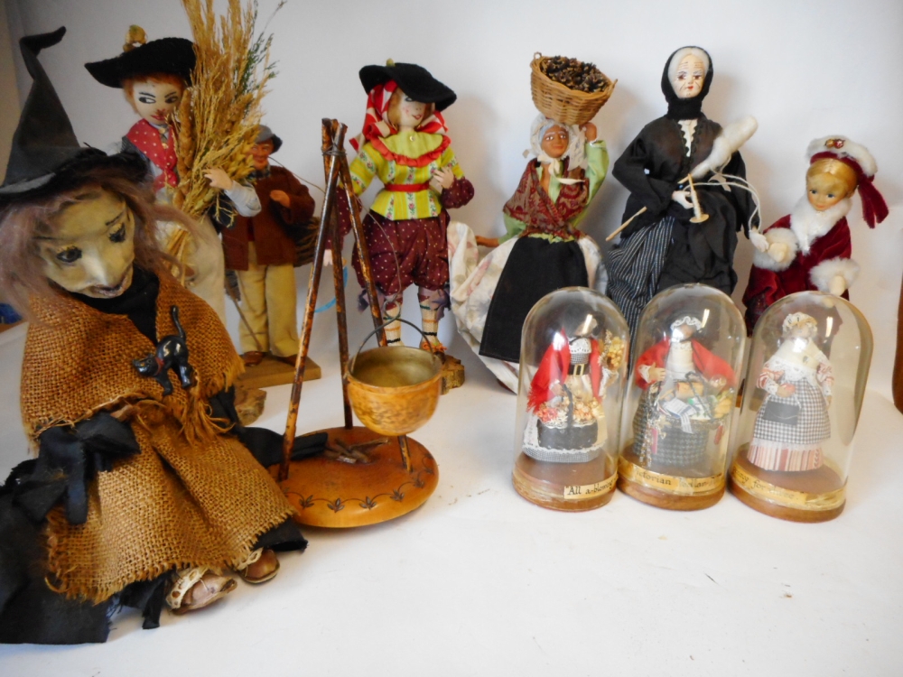 A box of assorted dolls: includes a seated witch by her cauldron,