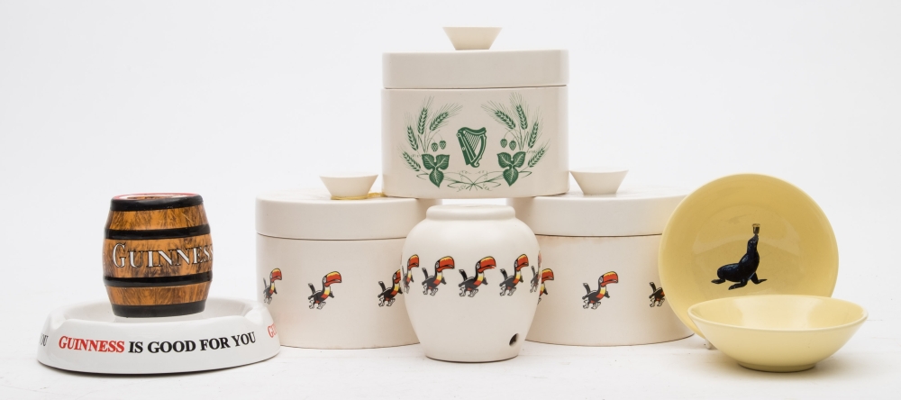 A Minton Guinness advertising ashtray together with two Carlton Ware Toucan pots and covers:,