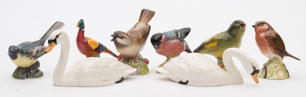 A Royal Worcester Porcelain model of a Sparrow, together with a group of seven Beswick birds:.